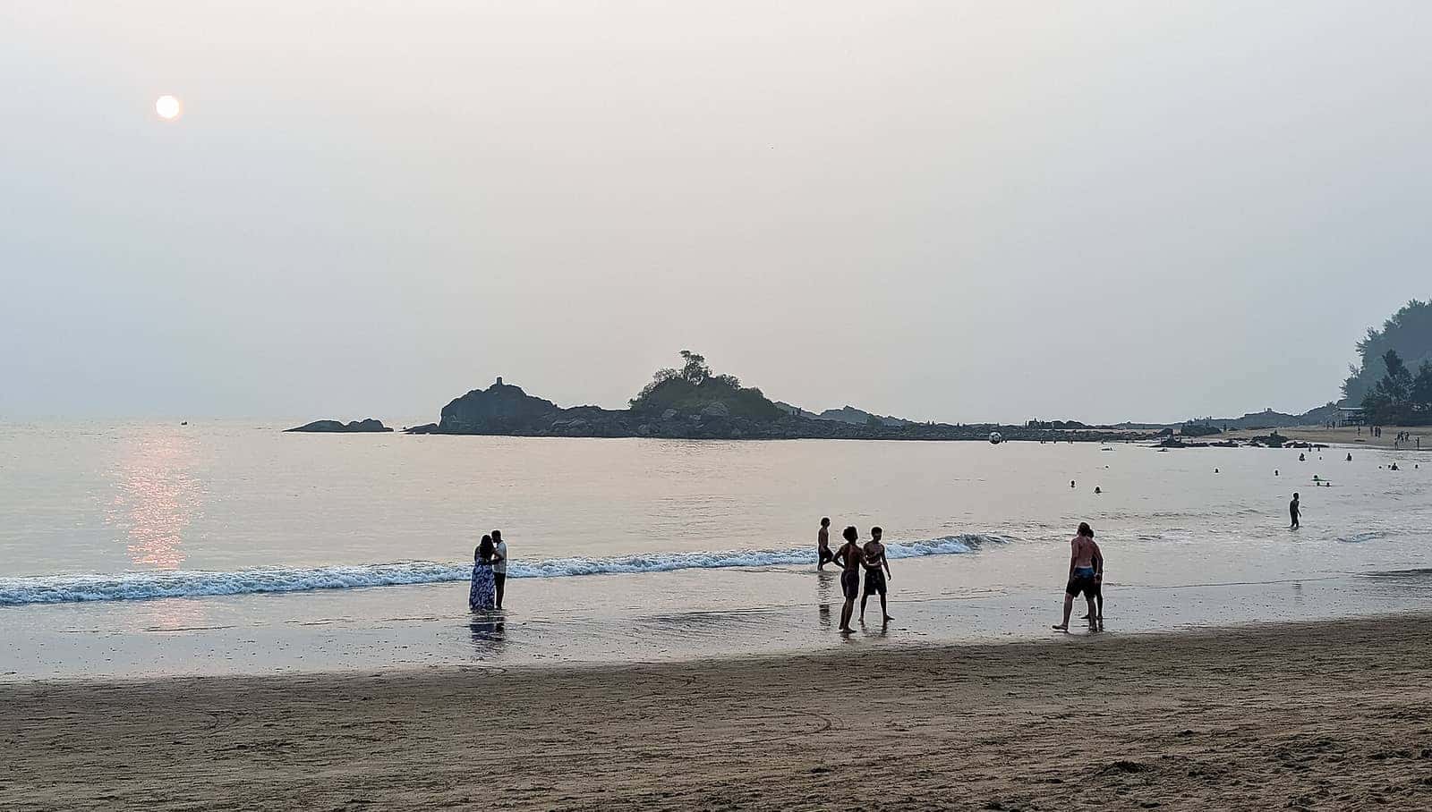 Evening at Om Beach in Gokarna with a rocky islet offshore